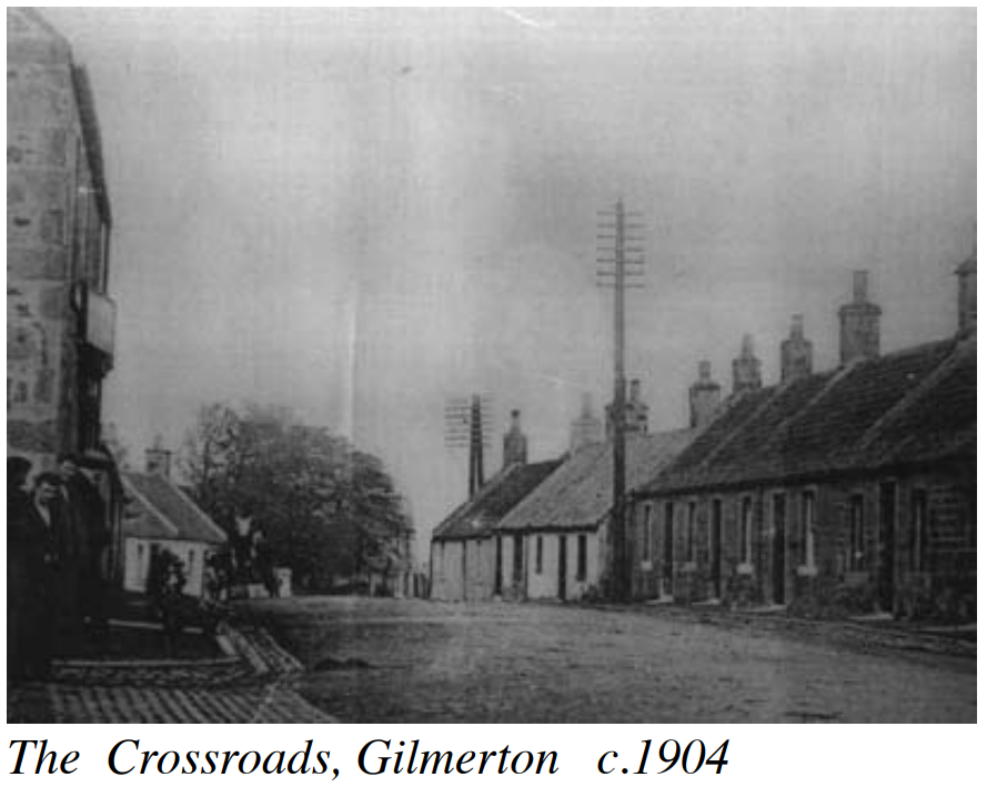 Historic black and white photo of Drum Street crossroads, Gilmerton - a junction with no cars on it and cottages in the background. Taken c1904.